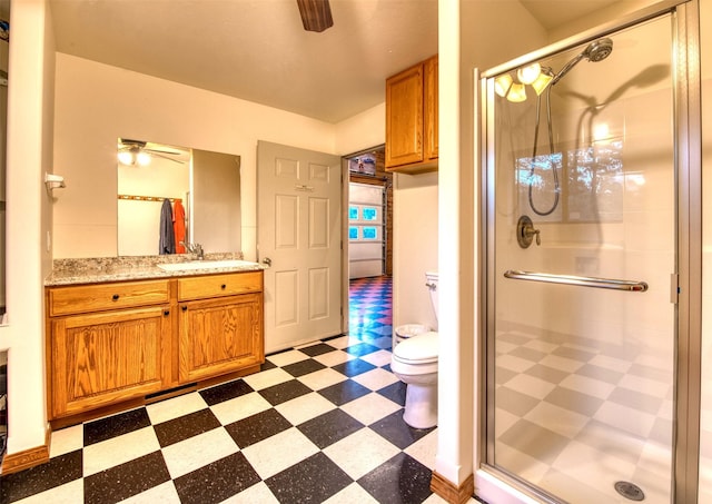 NHN Bears Rd, Stevensville, MT 59870 - bathroom featuring tile patterned floors, toilet, vanity, a ceiling fan, and a shower stall