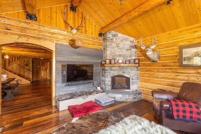 587 Cozy Ln, Helmville, MT 59843 - living area featuring stairway, rustic walls, beam ceiling, hardwood / wood-style flooring, and a fireplace