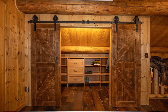 587 Cozy Ln, Helmville, MT 59843 - interior details with wood walls, a barn door, and wood finished floors
