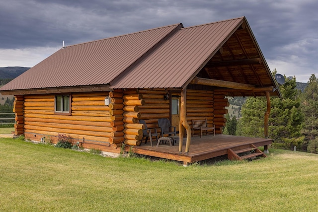 587 Cozy Ln, Helmville, MT 59843 - rear view of house featuring a lawn, metal roof, and log exterior