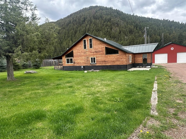 28 Princeton Rd, Philipsburg, MT 59858 - view of side of home with a forest view, a lawn, an outbuilding, and a mountain view