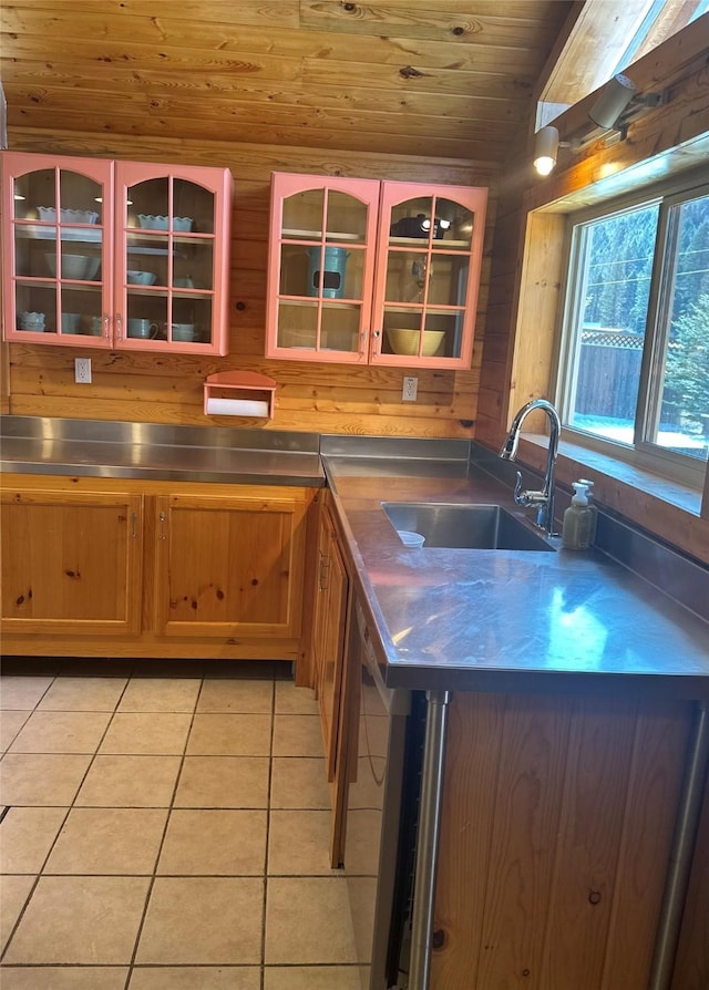 28 Princeton Rd, Philipsburg, MT 59858 - kitchen with stainless steel counters, a sink, wood ceiling, light tile patterned flooring, and glass insert cabinets