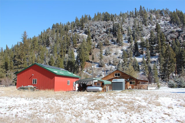 28 Princeton Rd, Philipsburg, MT 59858 - snow covered structure with a storage unit and a view of trees
