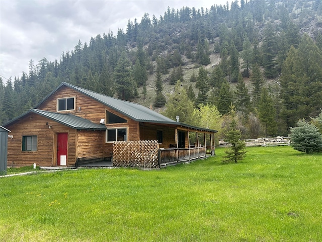 28 Princeton Rd, Philipsburg, MT 59858 - view of front of home with a front yard, a view of trees, and metal roof