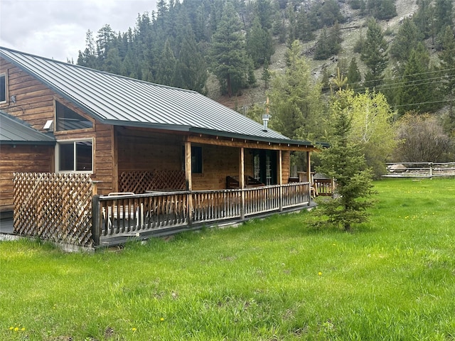 28 Princeton Rd, Philipsburg, MT 59858 - back of house with a standing seam roof, a yard, and metal roof