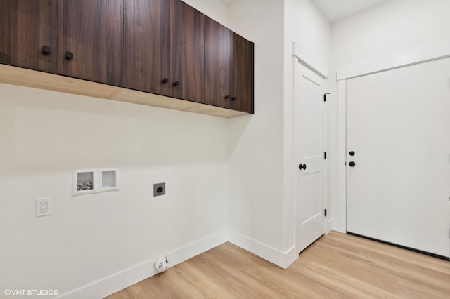 34 Grizzly Ct, Bigfork, MT 59911 - laundry room with electric dryer hookup, cabinet space, light wood-style flooring, hookup for a washing machine, and baseboards