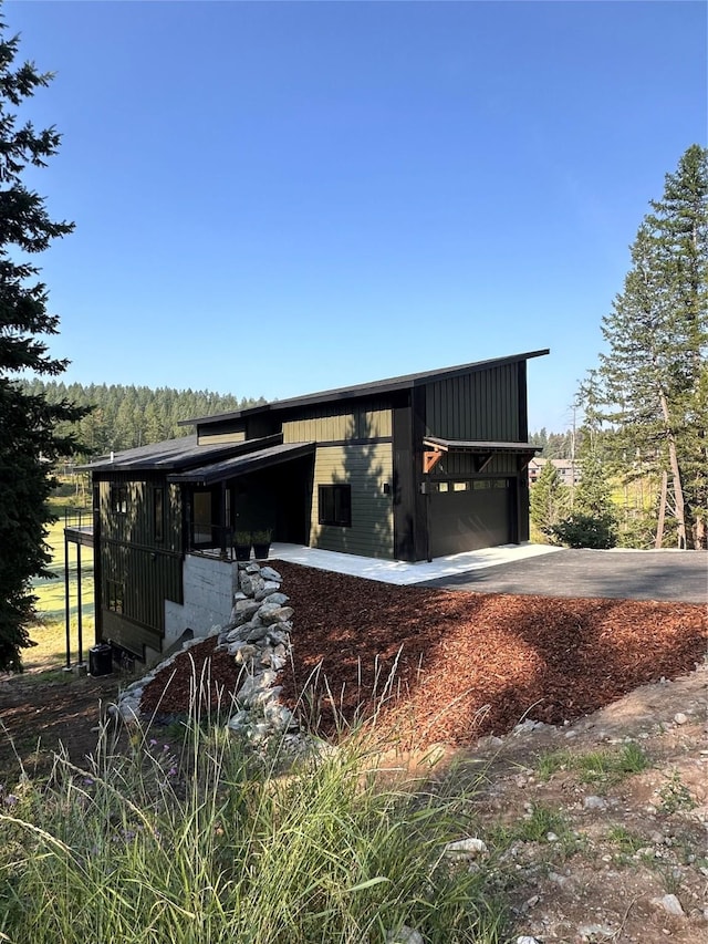 34 Grizzly Ct, Bigfork, MT 59911 - rear view of house with concrete driveway and an outbuilding
