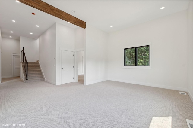 34 Grizzly Ct, Bigfork, MT 59911 - empty room featuring light colored carpet, baseboards, recessed lighting, and stairway
