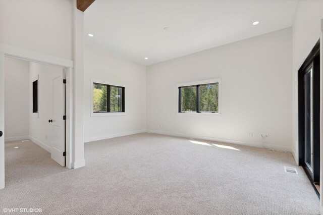 34 Grizzly Ct, Bigfork, MT 59911 - unfurnished bedroom with carpet, multiple windows, and recessed lighting