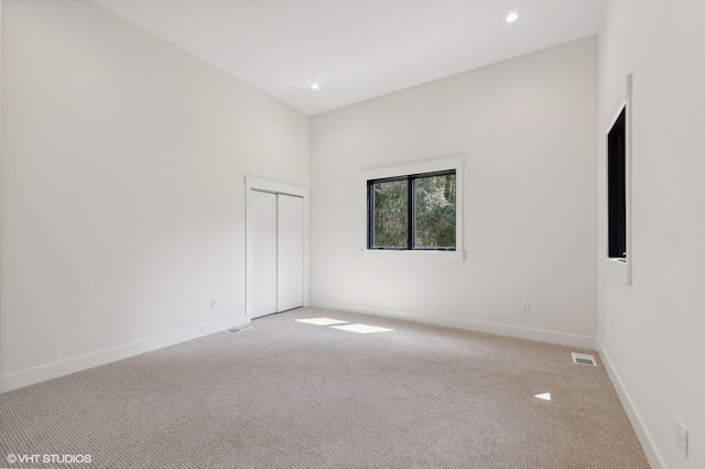 34 Grizzly Ct, Bigfork, MT 59911 - unfurnished room with light carpet, baseboards, and recessed lighting
