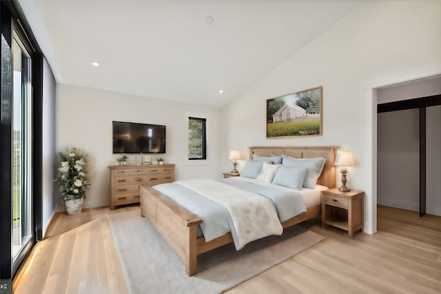 34 Grizzly Ct, Bigfork, MT 59911 - bedroom with light wood-style floors, lofted ceiling, and recessed lighting
