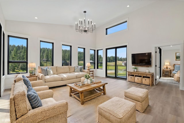 34 Grizzly Ct, Bigfork, MT 59911 - living room with a chandelier, light wood-style floors, a high ceiling, and recessed lighting