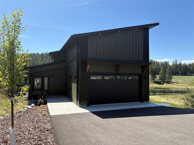 34 Grizzly Ct, Bigfork, MT 59911 - view of front of property with a garage and driveway