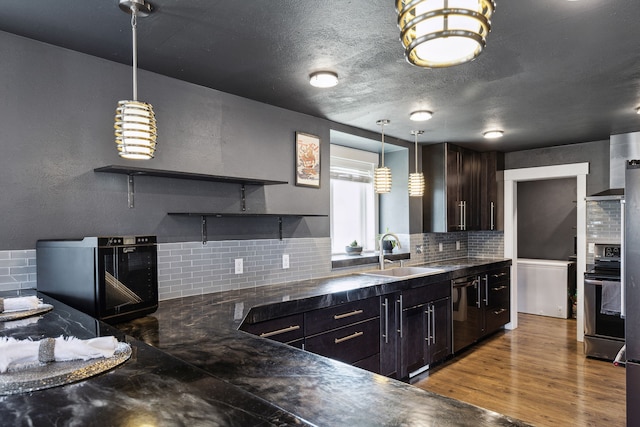 4528 Adellon Ct, Stevensville, MT 59870 - kitchen with open shelves, decorative backsplash, dark countertops, and wall oven