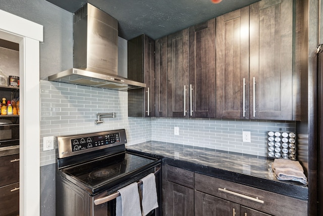 4528 Adellon Ct, Stevensville, MT 59870 - kitchen with wall chimney range hood, stainless steel range with electric stovetop, tasteful backsplash, and dark brown cabinets