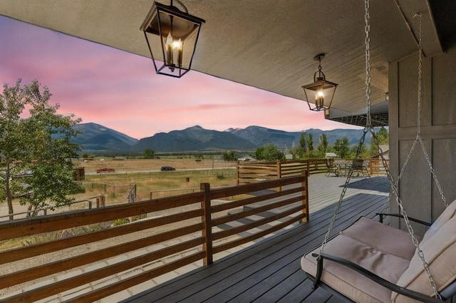 4528 Adellon Ct, Stevensville, MT 59870 - deck at dusk with a mountain view and a view of countryside