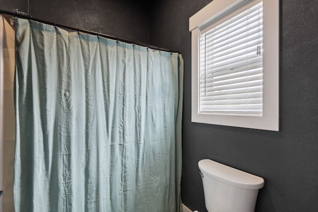 4528 Adellon Ct, Stevensville, MT 59870 - full bath featuring a textured wall and a shower with shower curtain