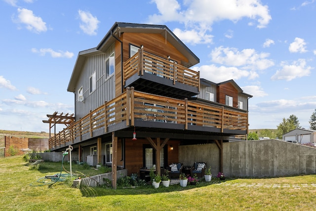 4528 Adellon Ct, Stevensville, MT 59870 - rear view of house with a balcony, a lawn, board and batten siding, and a deck