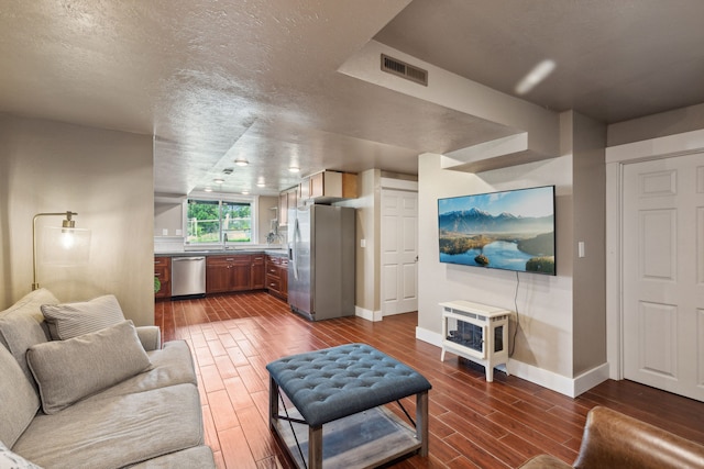 4528 Adellon Ct, Stevensville, MT 59870 - living room with dark wood-type flooring, a textured ceiling, and a wood stove