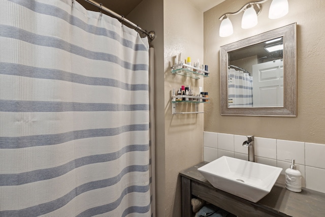 4528 Adellon Ct, Stevensville, MT 59870 - full bathroom with tile walls, a textured wall, a shower with curtain, and tasteful backsplash