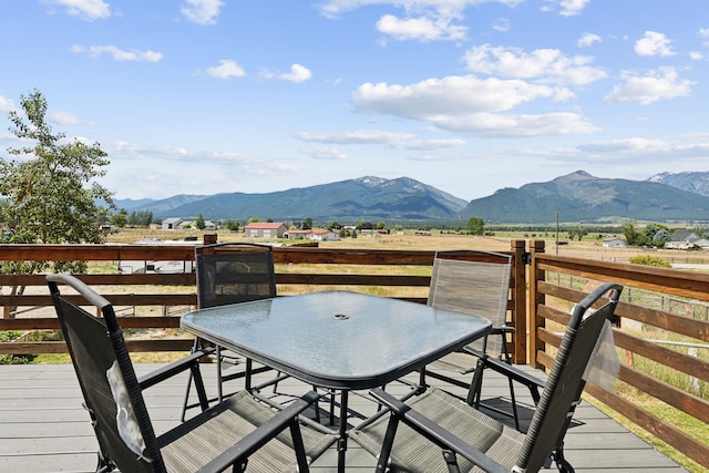 4528 Adellon Ct, Stevensville, MT 59870 - wooden terrace with a mountain view and outdoor dining area