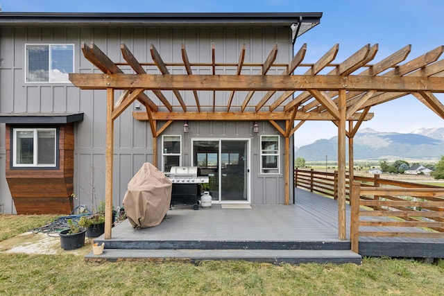 4528 Adellon Ct, Stevensville, MT 59870 - rear view of property with a deck with mountain view, board and batten siding, and a pergola