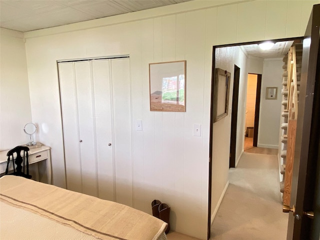 bedroom featuring a closet and light colored carpet