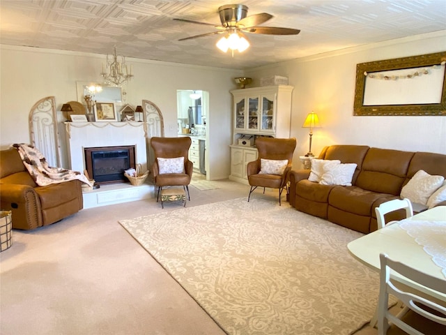 living room with ornamental molding, an ornate ceiling, light colored carpet, and ceiling fan