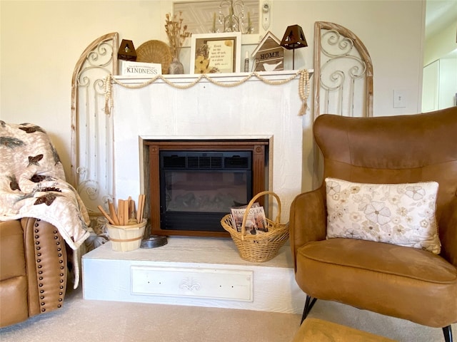 sitting room featuring a glass covered fireplace
