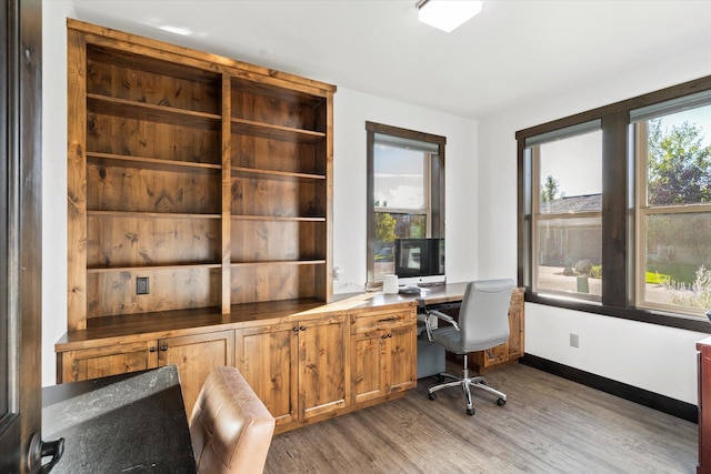 805 Broken Choker Ln, Bigfork, MT 59911 - office with wood finished floors, baseboards, and built in desk