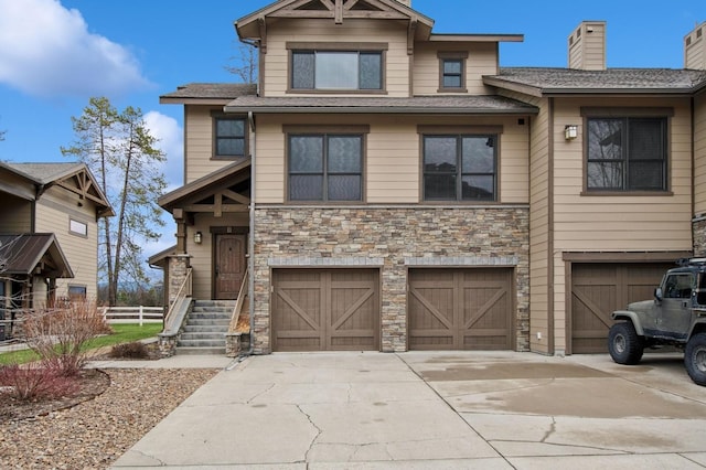 6205 Davos Ln Unit B, Whitefish, MT 59937 - view of front of property with an attached garage, stone siding, and driveway