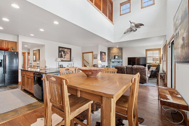6205 Davos Ln Unit B, Whitefish, MT 59937 - dining space featuring dark wood-style flooring, recessed lighting, healthy amount of natural light, and a towering ceiling