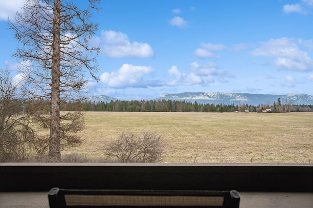6205 Davos Ln Unit B, Whitefish, MT 59937 - view of green lawn featuring a mountain view, a rural view, and a view of trees