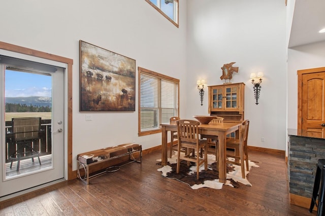 6205 Davos Ln Unit B, Whitefish, MT 59937 - dining area featuring plenty of natural light, a high ceiling, and dark wood-style flooring