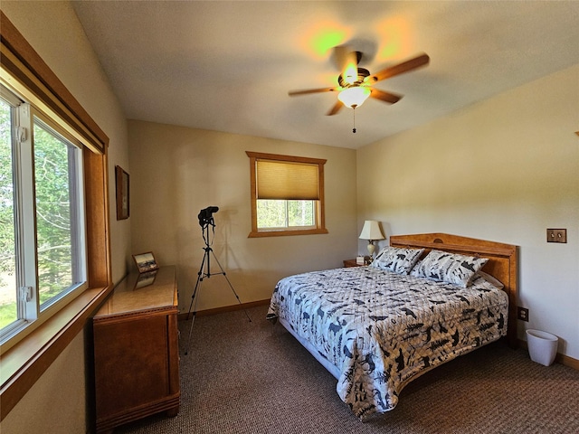 bedroom with dark carpet, baseboards, and a ceiling fan
