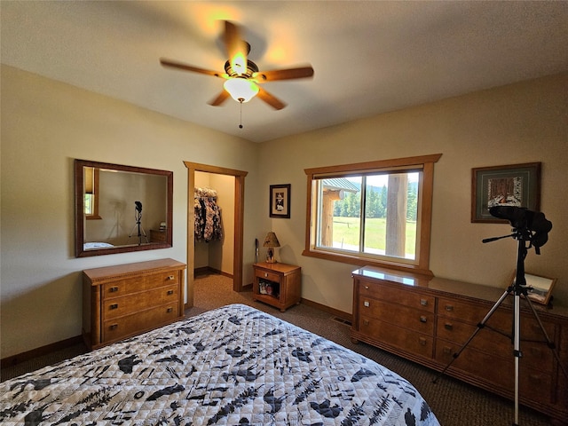 carpeted bedroom with a closet, a spacious closet, ceiling fan, baseboards, and visible vents