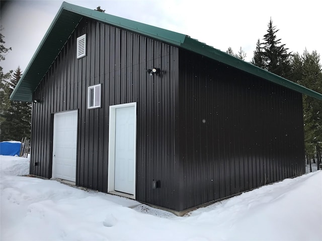 snow covered structure with an outdoor structure