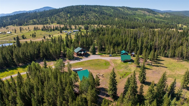 bird's eye view with a forest view and a mountain view