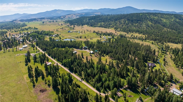 aerial view with a wooded view and a mountain view