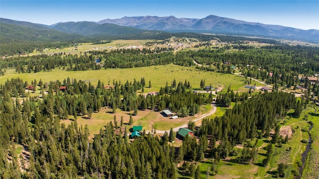 bird's eye view featuring a forest view and a mountain view