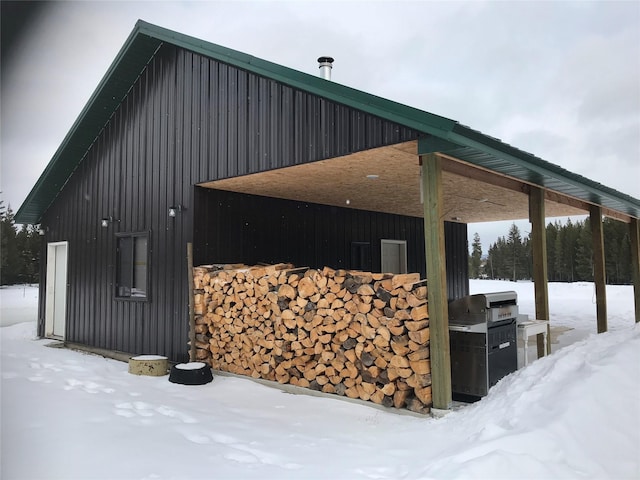 view of snow covered exterior featuring board and batten siding