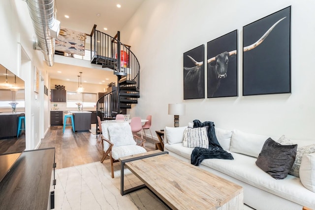15 Sagebrush Ct Unit B, Whitefish, MT 59937 - living area with stairs, light wood-style floors, a high ceiling, and recessed lighting