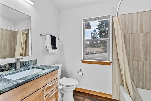 563 Riding High Dr, Eureka, MT 59917 - full bath featuring vanity, toilet, shower / tub combo with curtain, and wood finished floors
