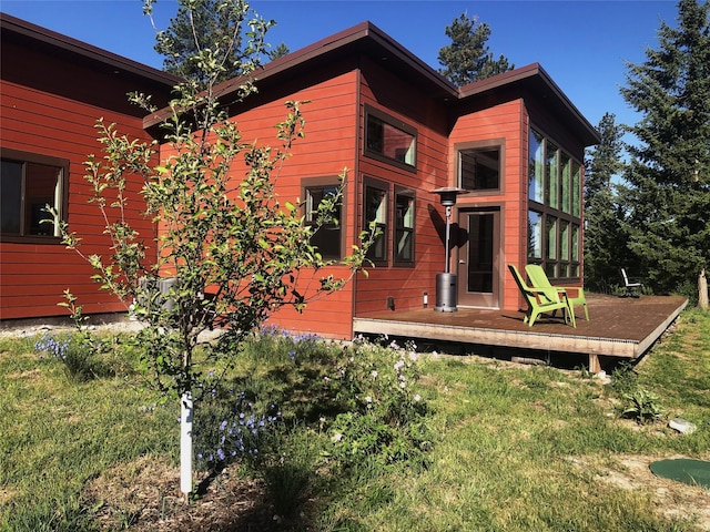 563 Riding High Dr, Eureka, MT 59917 - back of house featuring a deck and a yard