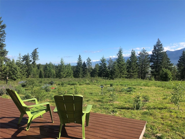 563 Riding High Dr, Eureka, MT 59917 - deck featuring a wooded view