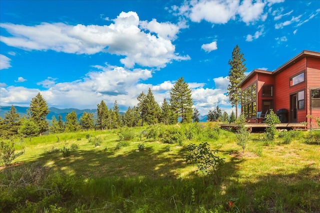 563 Riding High Dr, Eureka, MT 59917 - view of yard featuring a deck with mountain view