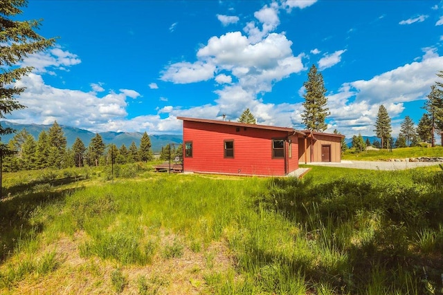 563 Riding High Dr, Eureka, MT 59917 - view of home's exterior featuring concrete driveway and a mountain view