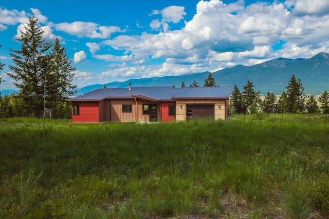 563 Riding High Dr, Eureka, MT 59917 - view of front of home with a mountain view, metal roof, and board and batten siding