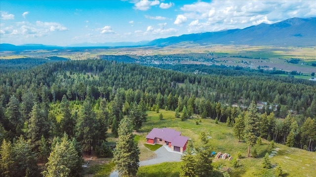 563 Riding High Dr, Eureka, MT 59917 - view from above of property with a heavily wooded area and a mountainous background