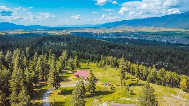 563 Riding High Dr, Eureka, MT 59917 - aerial view of a heavily wooded area and a mountainous background